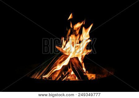 Brazier Or Fire Bowl With Burning Wood Logs In Front Of Black Background, Campfire At Night