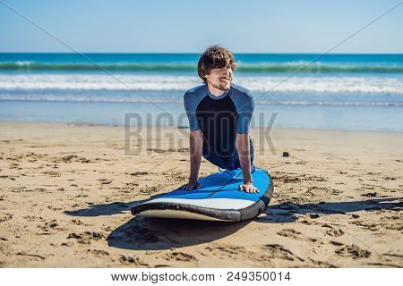 Young Man Surfer Training Before Go To Lineup On A Sand Beach. Learning To Surf. Vacation Concept. S