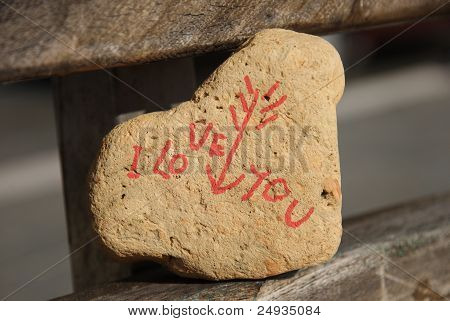 I love you message on a stone on a public bench