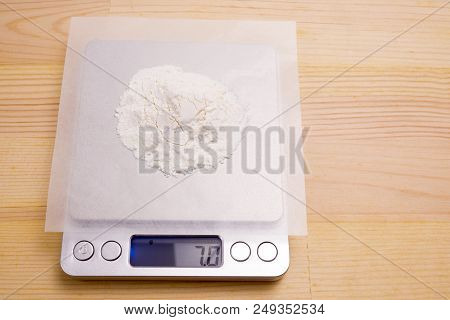 White Medicine Powder On Paraffin Paper Weighed With Electronic Scale
