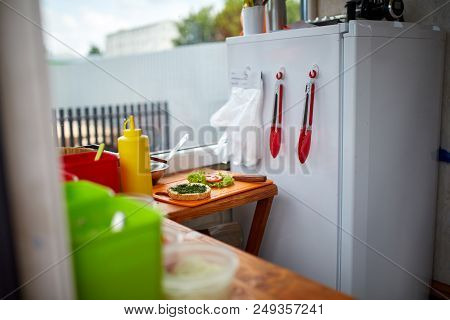 While Preparing Delicious Burger In Open Kitchen, Street Food Concept. Street Food Market Vendor. De