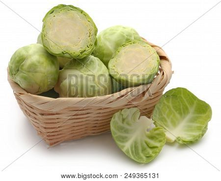 Rosenkohl Or Brussels Sprouts In A Basket Isolated Over White Background
