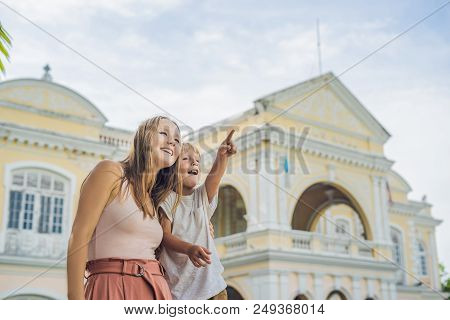 Mom And Son On Background Of Old Town Hall In George Town In Penang, Malaysia. The Foundation Stone 