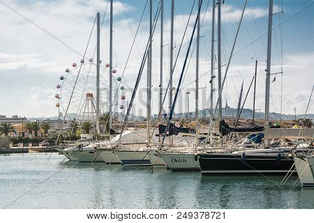 Pescara, Italy - May 20, 2018: Boats Moored In The Marina Of Pescara At Sunset And The Ferris Wheel 