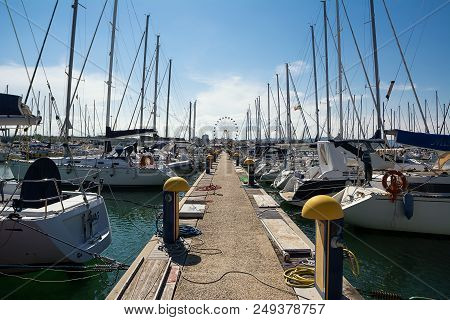 Pescara, Italy - May 20, 2018: Boats Moored In The Marina Of Pescara And The Ferris Wheel Background