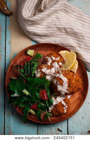 Beet Falafel With Tahina  Sauce And Green . Salad Selective Focus