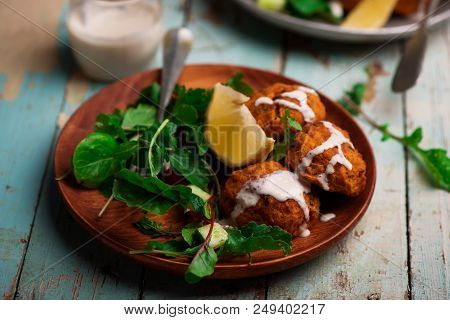 Beet Falafel With Tahina  Sauce And Green . Salad Selective Focus