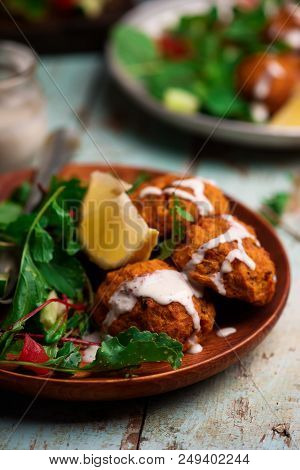 Beet Falafel With Tahina  Sauce And Green . Salad Selective Focus