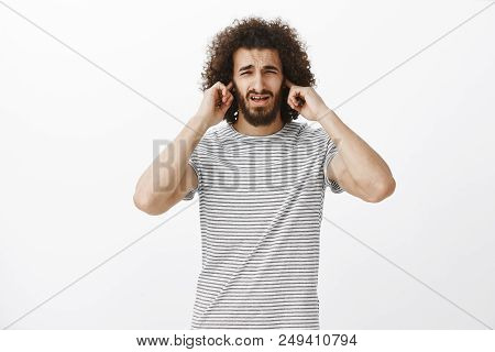 Man, Your Play Is Awful. Portrait Of Displeased Uncomfortable Attractive Hispanic Guy With Beard And