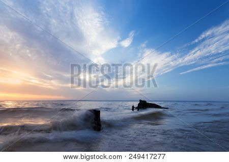 Morning Dawn Log On The Shore / Calm Water River Near The City