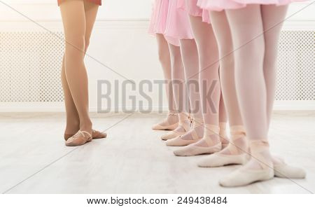 Ballet Background, Young Ballerinas Training. Female Dancers Legs In Pointe Shoes, Making Exercises.