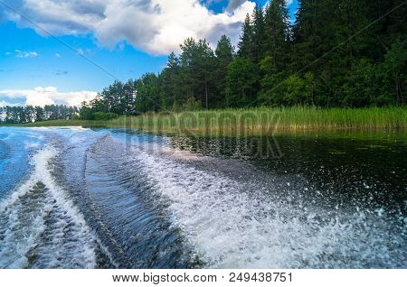 Foamy Trail On The Water Surface Behind The Fast Moving Motorboat. The Lake Seliger, Russia. Admirab
