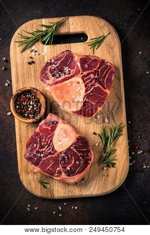 Raw Beef Steak Osso Bucco With Spices And Herbs. Ready To Cooking. View From Above Close Up.