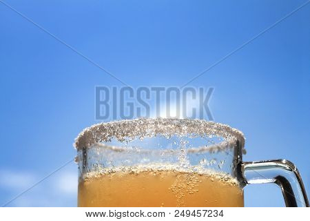 A Mexican Beer Mug Against A Blue Sky.