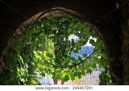 An Archway In The Lebanese Village Of Douma In Lush Green.