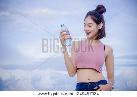 Healthy Girl's Drinking Water In The Bottle , Drink For Thirstily For Refreshing