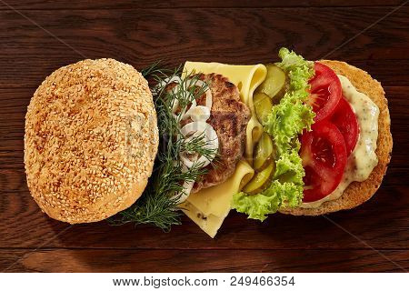 Close-up Of Delicious Fresh Home Made Burger With Piccoli, Lettuce, Cheese, Onion, Tomato, Dill And 
