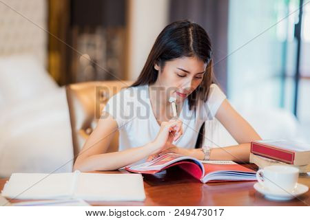 Asian Lady Student Read A Text Book For Prepare To Examination On The Bedroom, This Immage Can Use F