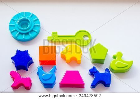 Set Of Toys For Babies On A White Table