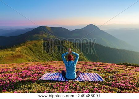 Colorful Carpet. The Yoga Girl In The Lotus Pose. The Lawn With The Rhododendron Flowers. High Mount