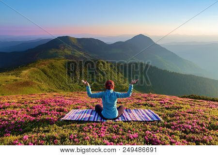 Colorful Carpet. The Yoga Girl In The Lotus Pose. The Lawn With The Rhododendron Flowers. High Mount