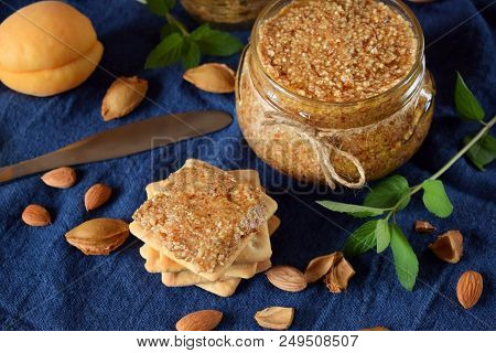 Urbech Of Apricot Kernels In A Glass Jar And On A Cracker