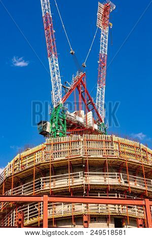 Construction Site With Cranes With Blue Sky Background
