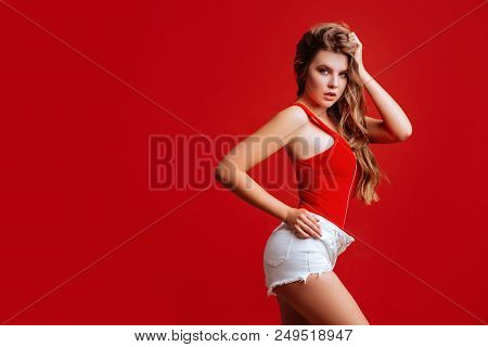 Pretty Bikini Model In Studio On Red Background