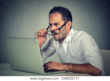 Closeup Portrait Business Man With Glasses Having Eyesight Problems Confused With Laptop Software Is