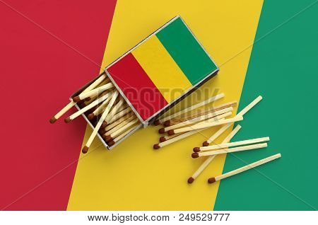 Guinea Flag  Is Shown On An Open Matchbox, From Which Several Matches Fall And Lies On A Large Flag.