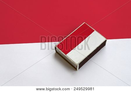 Indonesia Flag  Is Pictured On A Matchbox That Lies On A Large Flag.