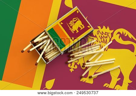 Sri Lanka Flag  Is Shown On An Open Matchbox, From Which Several Matches Fall And Lies On A Large Fl
