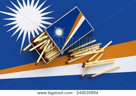 Marshall Islands Flag  Is Shown On An Open Matchbox, From Which Several Matches Fall And Lies On A L