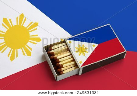 Philippines Flag  Is Shown In An Open Matchbox, Which Is Filled With Matches And Lies On A Large Fla