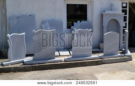 A Small Private Firm That Produces Gravestones Exposes Samples Of Its Products Along The Sidewalk