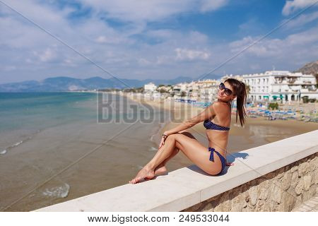 Young Tourist Woman On The Beach And Sea Landscape With Sperlonga, Lazio, Italy. Scenic Resort Town 