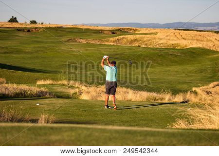 Male Golfer Hits A Tee Shot On Par 3