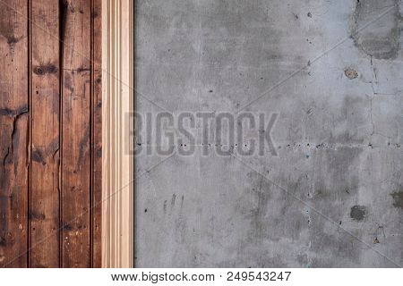 Detailed background texture of old and worn timber panels and cracked concrete