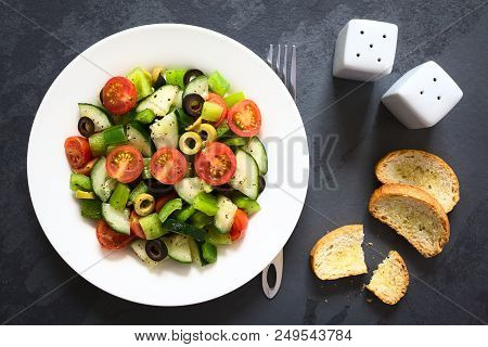 Fresh Salad Of Black And Green Olives, Cherry Tomatoes, Green Bell Pepper And Cucumber, Seasoned Wit