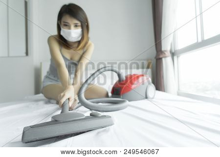 Woman Using Vacuum Cleaner While Cleaning White Bed At Home
Beautiful Young Asian Girl Cleaning Bed 