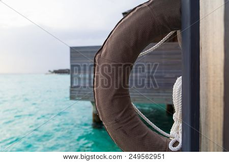 Beautiful Tropical Maldives Island Summer Vacation With Life Ring In Luxury Resport Background.