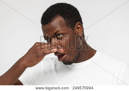 Horizontal Indoor Headshot Of Young African American Man Pictured Isolated On Gray Background Holdin