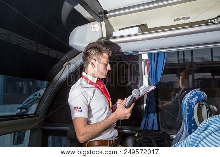 Marmaris, Turkey - May 19, 2018: Male Tour Guide With A Microphone In The Bus In Evening Time