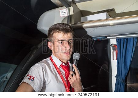 Marmaris, Turkey - May 19, 2018: Male Tour Guide With A Microphone In The Bus In Evening Time