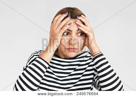 Horizontal Studio Portrait Of Desperate Beautiful Young Woman Having Stressed Facial Expression, Hol