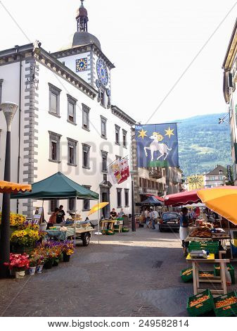 Sion, Switzerland - June 29, 2012: Local Vendors Sell Products In Flea Market At The Town Center Of 