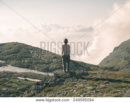 One Person Backpacker Looking At View High Up On The Alps. Expasive Landscape, Idyllic View At Sunse