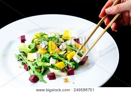 Process Of Eating With Chinese Chopsticks Delicious And Appetizing Salad With Beetroot And Fruit Man