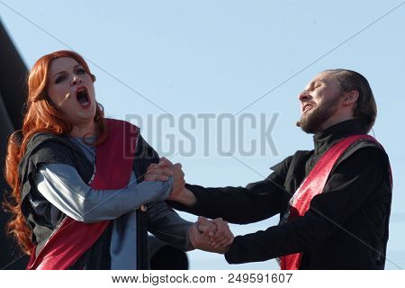 ST. PETERSBURG, RUSSIA - JULY 15, 2018: Dmitry Kondratiev as Macbeth (right) and Julia Gertseva as Lady Macbeth in the opera Macbeth outdoors during the festival All Together Opera