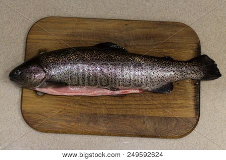Raw Fish. Raw Fresh Trout On A Table On A Cutting Board. Kitchen